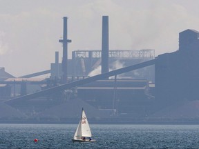 A sailboat sails past the Stelco plant in Hamilton on Aug. 27, 2007. (THE CANADIAN PRESS/Adrian Wyld)