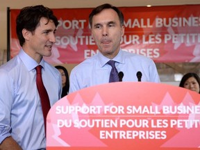 Finance Minister Bill Morneau speaks to members of the media as Prime Minister Justin Trudeau looks on at a press conference on tax reforms in Stouffville, Ont., on Monday, October 16, 2017.