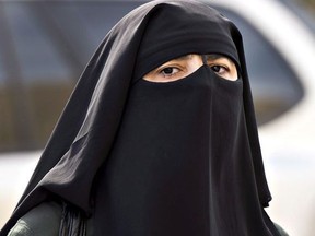 A woman wears a niqab as she walks Sept. 9, 2013 in Montreal.