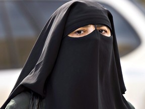 A woman wears a niqab as she walks in Montreal. Sri Lanka has banned niqabs and burqas in the wake of terror attacks.