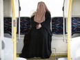 Warda Naili poses for a photograph on a city bus in Montreal, Saturday, October 21, 2017.