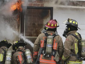 This file photo shows Toronto Firefighters dousing a fire  at a home in the Keele St.-Wilson Ave. area.