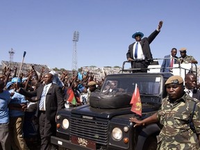 Malawi's President Peter Mutharika waves at people who gathered to witness his official inauguration as President at the Kamuzu stadium in Blantyre on June 2, 2014.