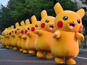 This file picture taken on August 2, 2015 shows costumed performers dressed as Pikachu, the popular animation Pokemon series character, attending a promotional event at the Yokohama Dance Parade in Yokohama. (KAZUHIRO NOGI / AFP Photo)