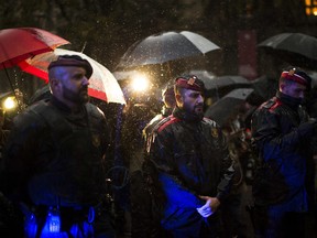 Catalan police officers cordon off the area as protesters gather at the gates of the Spanish central government offices in Barcelona to protest against the National Court's decision to imprison civil society leaders, Spain, Thursday, Oct. 19, 2017. A National Court judge ordered the preventive jailing of ANC's Jordi Sanchez and Omnium's Jordi Cuixart for allegedly orchestrating protests in mid-September that hindered a judicial probe into preparations for the Oct. 1 referendum that has been deemed unconstitutional. (AP Photo/Emilio Morenatti)
