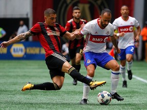 Carlos Carmona #14 of Atlanta United challenges Victor Vazquez #7 of Toronto FC at Mercedes-Benz Stadium on October 22, 2017 in Atlanta, Georgia. (Photo by Kevin C. Cox/Getty Images)