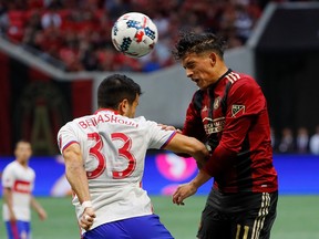 Yamil Asad #11 of Atlanta United wins a header against Steven Beitashour #33 of Toronto FC at Mercedes-Benz Stadium on October 22, 2017 in Atlanta, Georgia. (Photo by Kevin C. Cox/Getty Images)