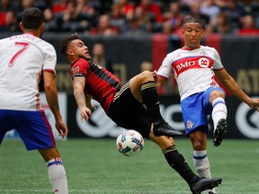 Hector Villalba #15 of Atlanta United challenges Justin Morrow #2 of Toronto FC at Mercedes-Benz Stadium on October 22, 2017 in Atlanta, Georgia.  (Photo by Kevin C. Cox/Getty Images)