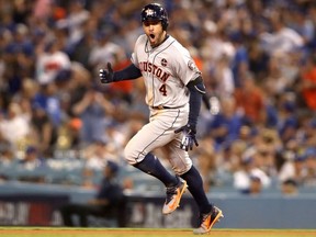 George Springer #4 of the Houston Astros celebrates after hitting a two-run home run during the eleventh inning against the Los Angeles Dodgers in game two of the 2017 World Series at Dodger Stadium on October 25, 2017 in Los Angeles, California. (Photo by Christian Petersen/Getty Images)
