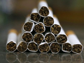 A picture taken on September 29, 2017 shows a close up shot a stack of cigarettes in Kuwait City. On October 1, 2017, the United Arab Emirates will double the price of tobacco and increase soft drink prices by 50 percent, ahead of a more general tax on goods and services on January 1 next year. It is but one of the six Gulf Cooperation Council states -- along with Saudi Arabia, Bahrain, Kuwait, Oman and Qatar -- to introduce the five-percent VAT next year as they seek to redress their economies.