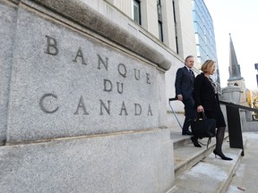 Governor of the Bank of Canada Stephen Poloz and Carolyn Wilkins, Senior Deputy Governor, make their way to the National Press Gallery in Ottawa on Wednesday, October 25, 2017. THE CANADIAN PRESS/Sean Kilpatrick