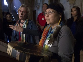 Surrounded by Chief Marcia Brown Martel and Sixties Scoop survivors, Crown-Indigenous Relations and Northern Affairs Minister Carolyn Bennett responds to a question during a news conference on Parliament Hill, in Ottawa on Friday, Oct. 6, 2017.
