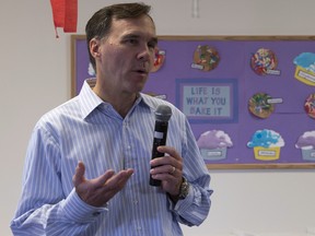 Minister of Finance Bill Morneau speaks with the media after touring a daycare centre for young mothers in Ottawa on Wednesday October 25, 2017. (Adrian Wyld/The Canadian Press)