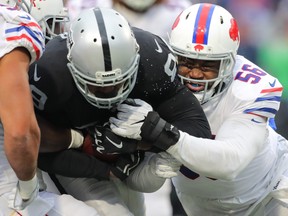 Amari Cooper of the Oakland Raiders runs the ball as Ryan Davis of the Buffalo Bills attempts to tackle him October 29, 2017 at New Era Field in Orchard Park, New York.