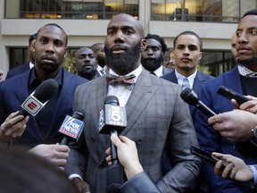 Former NFL football player Anquan Boldin (left), Philadelphia Eagles Malcolm Jenkins (centre), and San Francisco 49ers Eric Reid answer questions outside the league's headquarters after meetings on Tuesday. (The Associated Press)