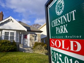 A "Sold" sign stands outside an existing home for sale in Toronto, Ontario, Canada, on Monday, Nov. 30, 2009.