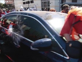 In this still image taken from video and released by Unite Here Local 11, a motorist drives his car into marchers at an immigrant rights rally in Brea, Calif., on Thursday, Oct. 26, 2017. (Antonio Mendoza/Unite Here Local 11 via AP)