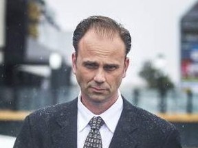 Toronto Police Sgt. Christopher Heard, seen here leaving court during an earlier appearance, had his two sex assault charges dismissed on Wednesday, Oct. 25, 2017. (file photo)