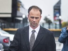 Toronto Police Sgt. Christopher Heard, seen here leaving court during an earlier appearance, had his two sex assault charges dismissed on Wednesday, Oct. 25, 2017. (file photo)