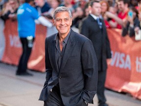 George Clooney smiles at photographers at the premiere of 'Suburbicon' at the Toronto International Film Festival Sept. 9, 2017. (GEOFF ROBINS/AFP/Getty Images)