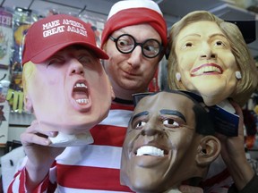 Geoff Waszek co-owner of the Candy's Costume Shop holds popular items on Wednesday October 25, 2017.