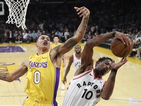 Toronto Raptors guard DeMar DeRozan, right, grabs a rebound away from Los Angeles Lakers forward Kyle Kuzma Friday, Oct. 27, 2017, in Los Angeles.