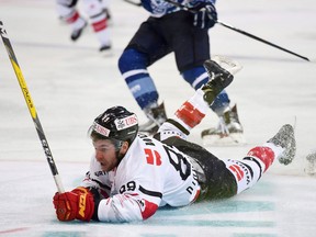 Canada's Chris Didomenico falls on the ice during the game between Dinamo Minsk and Team Canada, at the 90th Spengler Cup hockey tournament in Davos, Switzerland, on Dec. 26, 2016. Chris DiDomenico was about as far away from the NHL as possible three years ago. The former sixth round pick of the Toronto Maple Leafs was playing in an Italian hockey League, a top scorer with a club in Asiago, a tiny, scenic northern Italian town in the foothills of the Alps. (THE CANADIAN PRESS/Keystone via AP, Melanie Duchene)