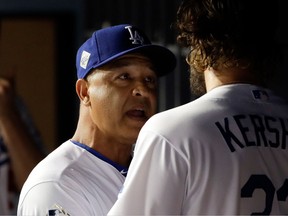 Dodgers manager Dave Roberts talks to Clayton Kershaw during Game 1 on Oct. 24, 2017. (AP)