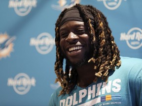 In this Sept. 29, 2017, file photo, Miami Dolphins running back Jay Ajayi laughs during a press conference after a training session at Allianz Park in London.
