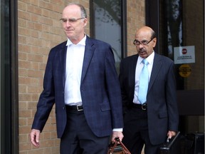 Dr. Ravi Shenava, right, and his lawyer, David Humphrey, leave the Superior Court of Justice on Oct. 23, 2017, in Windsor