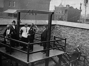 Canada's hangman John Radclive, far right, proceeds over the last public hanging in Canada in 1902.