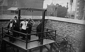 Canada's hangman John Radclive, far right, proceeds over the last public hanging in Canada in 1902.