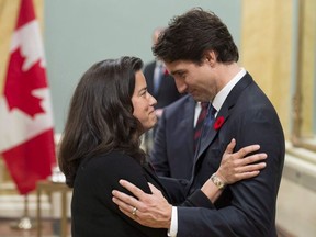 Prime Minister Justin Trudeau embraces Minister of Justice Jody Wilson-Raybould during a swearing-in ceremony at Rideau Hall, in Ottawa in a November 4, 2015, file photo. THE CANADIAN PRESS/Adrian Wyld