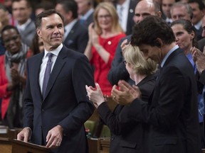 Minister of Finance Bill Morneau is given a standing ovation as he presents the fall fiscal update in the House of Commons, Tuesday, October 24, 2017 in Ottawa. THE CANADIAN PRESS/Adrian Wyld