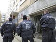 Police stand in front of a building in the northeastern German city of Schwerin Tuesday, Oct. 31, 2017.