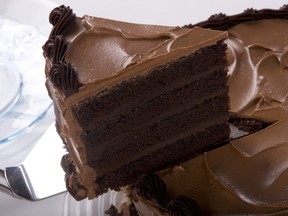 Chocolate cake with a slice being taken.
