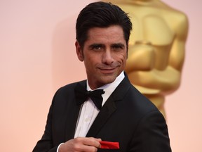 John Stamos arrives on the red carpet for the 87th Oscars February 22, 2015 in Hollywood, California. (MARK RALSTON/AFP/Getty Images)