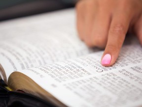 In this stock photo, a women reads the Bible.