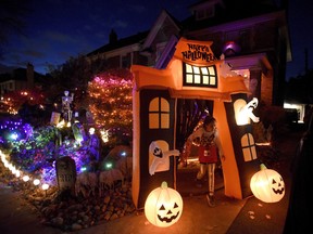 A girl trick-or-treats at a decorated home in Ottawa on Halloween, Monday, Oct. 31, 2016.