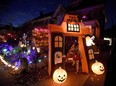 A girl trick-or-treats at a decorated home in Ottawa on Halloween, Monday, Oct. 31, 2016.