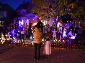 People go trick-or-treating at a decorated home in the Glebe neighbourhood in Ottawa on Halloween on October 31, 2016. THE CANADIAN PRESS/Justin Tang