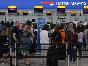 In this file photo, passengers arrive with their luggage in Terminal 5 of London's Heathrow Airport on May 29, 2017.
 (DANIEL LEAL-OLIVAS/AFP/Getty Images)