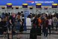 In this file photo, passengers arrive with their luggage in Terminal 5 of London's Heathrow Airport on May 29, 2017.
 (DANIEL LEAL-OLIVAS/AFP/Getty Images)