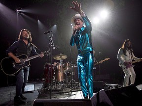 The Tragically Hip frontman Gord Downie, centre, leads the band through a concert in Vancouver, Sunday, July 24, 2016.THE CANADIAN PRESS/Jonathan Hayward
