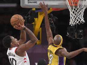 Toronto Raptors guard DeMar DeRozan, left, shoots as Los Angeles Lakers guard Corey Brewer defends during the second half of an NBA basketball game, Friday, Oct. 27, 2017, in Los Angeles. The Raptors won 101-92. (AP Photo/Mark J. Terrill)
