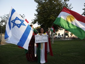 Members of the Kurdish Jewish community hold Israeli and Kurdish flags during a demonstration near the American consulate in Jerusalem on Sept. 24, 2017, in support of the referendum on independence in Iraq's autonomous Kurdish region. (AHMAD GHARABLI/Getty Images)