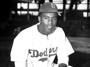 In this April 11, 1947 file photo, Jackie Robinson of the Brooklyn Dodgers poses at Ebbets Field in the Brooklyn borough of New York.