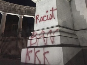 The statue of Confederate States of America President Jefferson Davis with the word 'racist' spray painted on it in Richmond, Va., on Oct. 17, 2017. (Graham Moomaw/Richmond Times-Dispatch via AP)