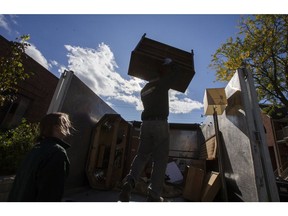 Jeremy Borda (top) and Liam Hamilton, of JUSTJUNK, clear out a home of things no longer needed in Toronto, Ont. on Wednesday October 25, 2017.