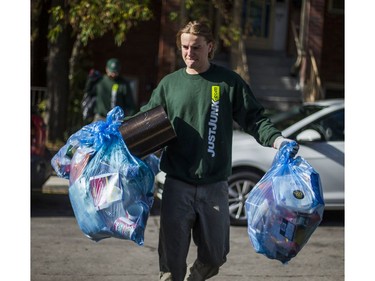 Liam Hamilton, of JUSTJUNK, helps to clear out various thing no longer needed from a home in Toronto, Ont. on Wednesday October 25, 2017.